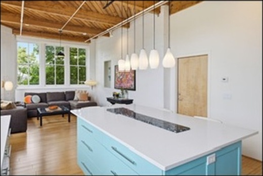 Kitchen island and living space under the fir ceiling
