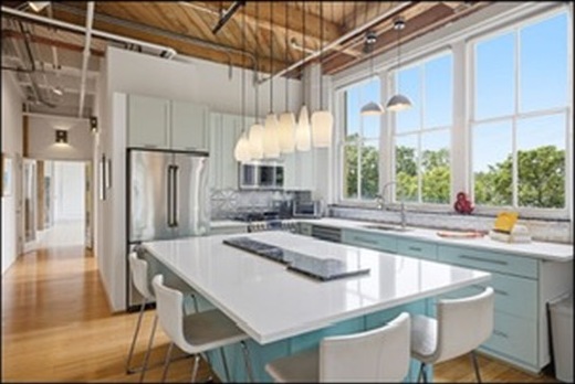 Kitchen with white island and wood ceiling