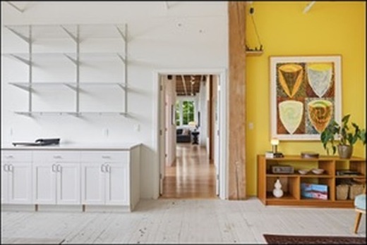 White kitchen against a yellow wall